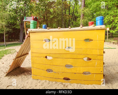 Wooden wall for climbing close up. Sports extreme for small children in public park Stock Photo