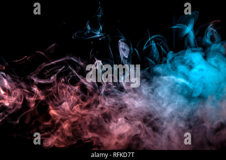 Translucent smoke rising to the top, illuminated by light on a dark background, multi-colored: blue, pink and grey, evaporating in waves exhaled from  Stock Photo