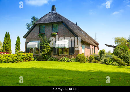 The thatched roof house with beatiful garden in fairytale village Giethoorn in The Netherlands. Stock Photo