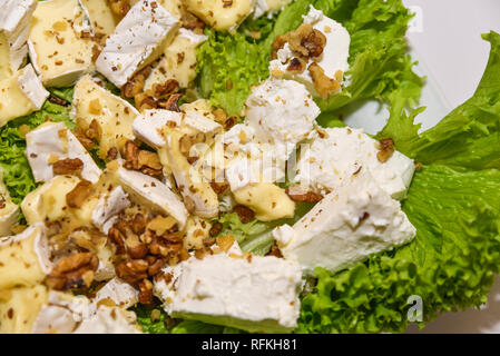 Cheese plate with various different kind of cheeses served on the table at the restaurant. Shallow  focus. Stock Photo