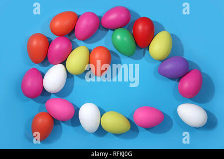 Multi colored easter eggs against a bright blue background. Stock Photo