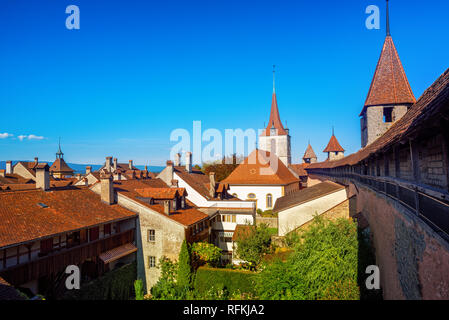 Red tiled roofs and wall towers in historical medieval Old Town Murten, Switzerland Stock Photo