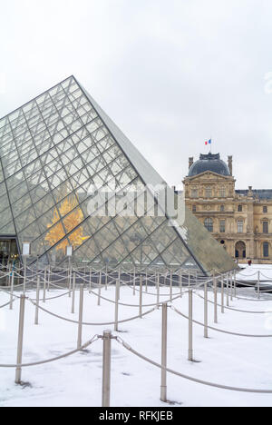 Pyramid and Louvre museum under snow, Paris, France Stock Photo