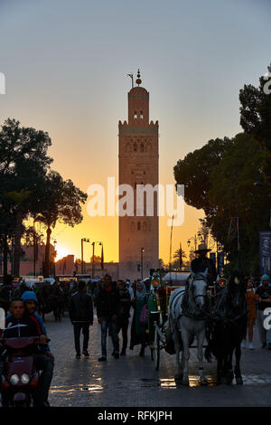 Minaret of Koutoubia Mosque at the sunset time with people, Marrakech / Marrakesh, Morocco Stock Photo