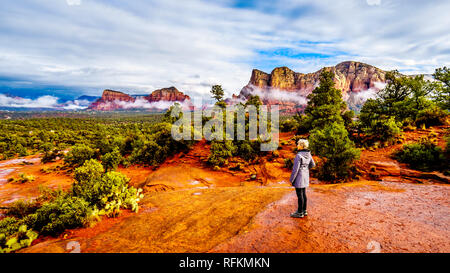 Senior woman enjoying the view at Lee Mountain and other red rock mountains surrounding  Sedona in northern Arizona in Coconino National Forest, USA Stock Photo