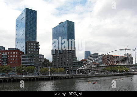 View on two towers Torres de Urbitrate and the pedestrian bridge over the Nervion river in Bilbao, Spain Stock Photo