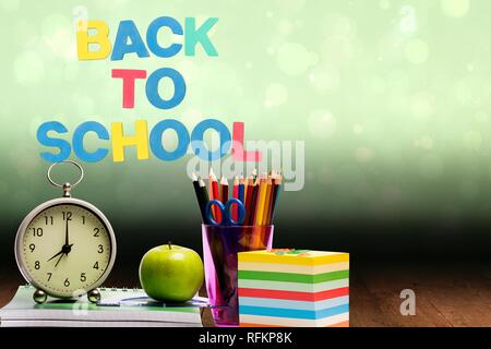 composite of back to school text with school materials and bright background Stock Photo
