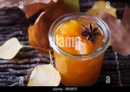 Jam with pumpkin on dark autumn wooden background Stock Photo