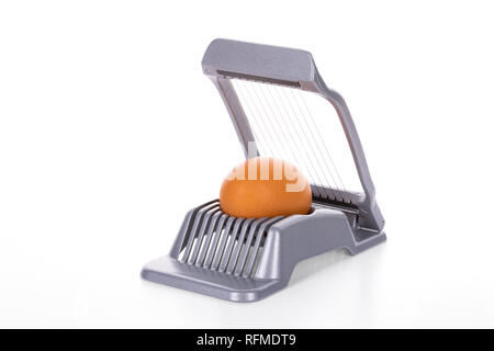 Egg cutter - slicer with brown egg on white background, clipping path, including all background elements, is included Stock Photo