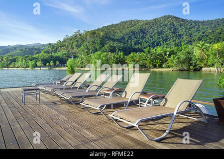 Beach chair with island background, Koh Chang, Trad Province, Thailand. Stock Photo