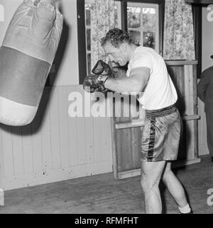 English heavyweight boxer Henry Cooper trying in a gym in England during the 1960s. Stock Photo