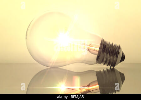 Old bulb filament isolated backlit on white background, conceptual image