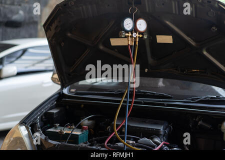 a car repaired by the air conditioner was tested by the dynamo using a pressure gauge Stock Photo