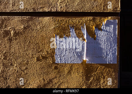 Rough textured painted wall with strong shadows cast by direct sunlight Stock Photo