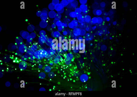 bundle of optic fibers in blue and green light Stock Photo