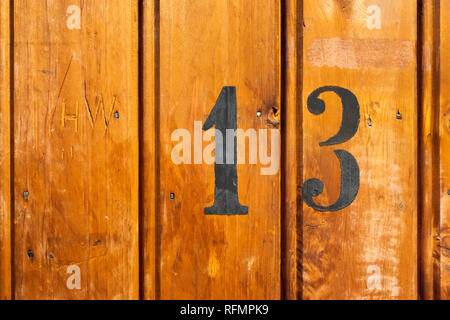 number 13 on door of storage room for tenants in century-old apartment building in stockholm Stock Photo
