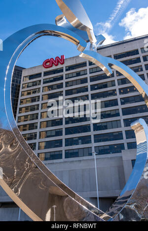CNN Center, world headquarters of the Cable News Network, seen through a large chromed Georgia peach sculpture in downtown Atlanta, Georgia. (USA) Stock Photo