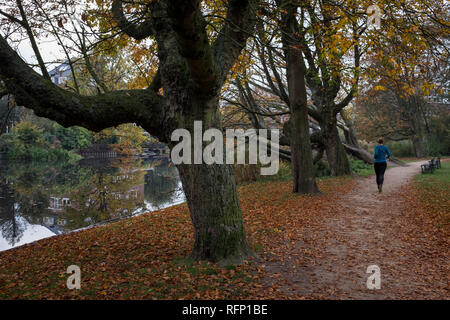 Amsterdam, Netherlands - 30 October 2016: Woman running at Vondelpark Stock Photo