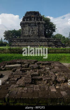 Mendut Buddhist temple, from the 9th century. In Borobudur, Java, Indonesia. Ruins of another temple are in the foreground.