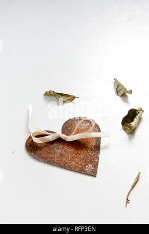 love symbol, rusty heart with dried leaves, isolated on white Stock Photo