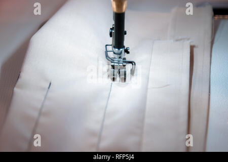 Close up of modern sewing machine and item of clothing, old sewing machine, vintage style Stock Photo
