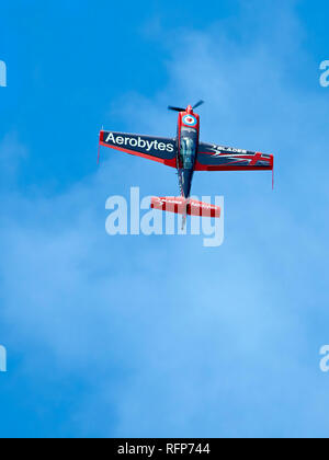 One of The Blades Display Team's Extra 300Ls climbs vertically into a blue sky. Stock Photo