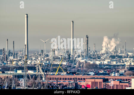 Rotterdam, The Netherlands, January 20, 2019: some wind turbines are visible in the Pernis industrial area that's otherwise still dominated by chimney Stock Photo