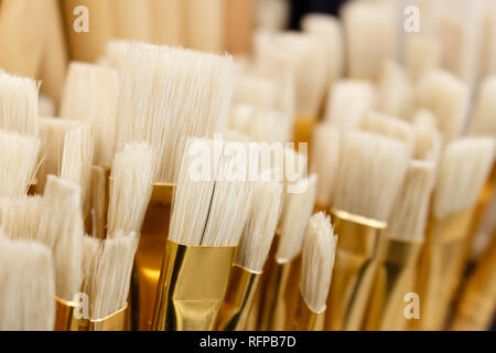 Lot of various paint brushes tool stayed close up to each other. Selective focus. Stock Photo