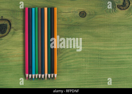 Image of crayons on wooden table.Toned image.Image contains little noise because of high ISO set on camera. Stock Photo