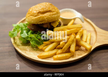 Cheeseburger And French Fries Served On Wooden Table Stock Photo