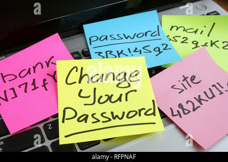 Change your password. Laptop with pieces of paper. Stock Photo