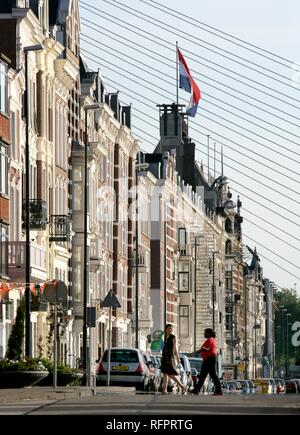 Apartment houses facades at the Maaskade, Steel ropes of the Erasmusbruk in the background, Rotterdam, Netherlands Stock Photo