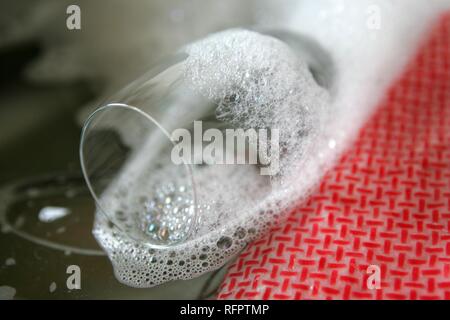 DEU, Germany: Cleaning of wine glasses by hand. Stock Photo