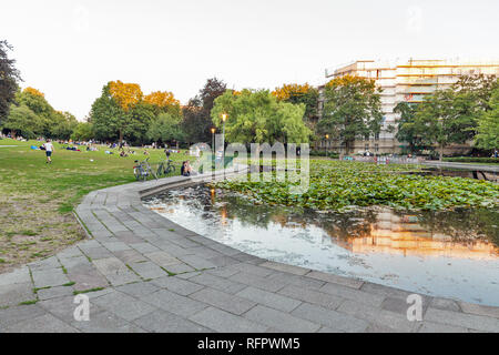 BERLIN, GERMANY - JULY 14, 2018: People have a rest near small lake in sunset city Volkspark on the Vineyard. Berlin is the capital and largest city o Stock Photo