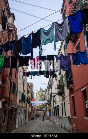 Narrow streets leading through the ailing brick houses of the so-called 'Floating city', laundry is put up on washing lines Stock Photo