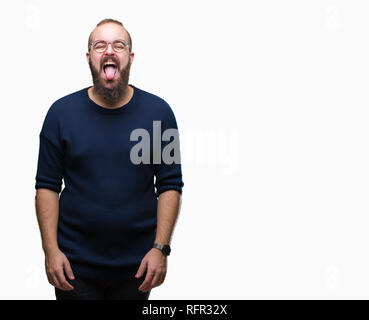 Young caucasian hipster man wearing sunglasses over isolated background sticking tongue out happy with funny expression. Emotion concept. Stock Photo