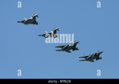 A mixed formation of RAF Typhoon FGR4s and USAF F-15C's recover back to RAF Coningsby during a combined exercise by the 493rd FS, USAF and 11 Sqn, RAF. Stock Photo