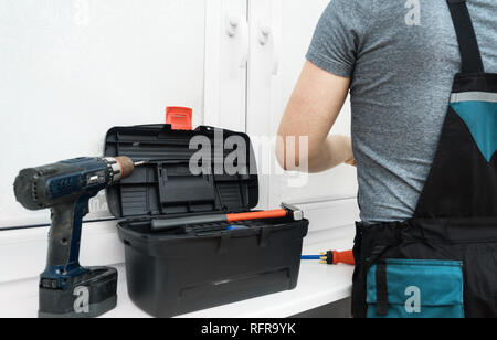Man installing cassette roller blinds on windows Stock Photo