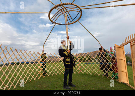 Kazakh men building nomadic tent known as yurt, in Saty Village, Kazakhstan. Stock Photo