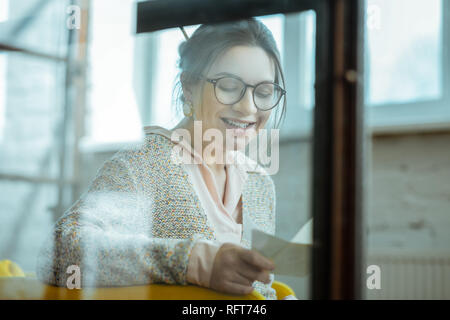 Cheerful beautiful woman wearing glasses smiling broadly Stock Photo