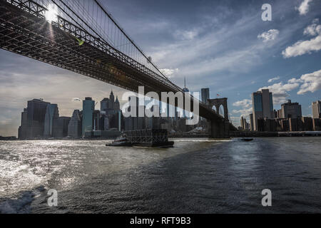 Manhattan seen from under Brooklyn Bridge. Stock Photo