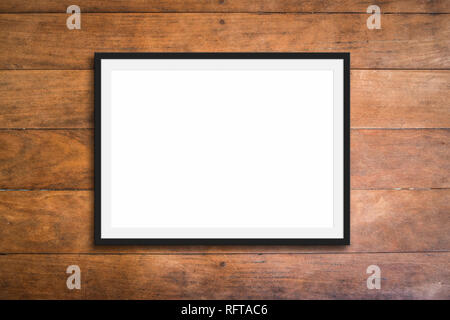 empty black frame on wooden background - picture mockup Stock Photo