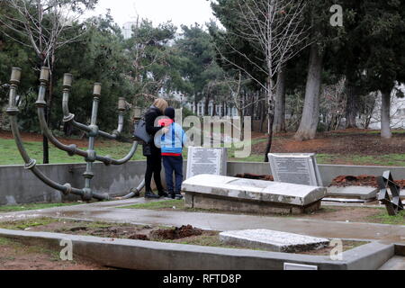 Thessaloniki, Greece. 26th Jan, 2019. People visit the vandalized memorial site. Vandals smashed a memorial to the Jewish cemetery on the campus of the Aristotle University of Thessaloniki. The campus monument commemorates the former centuries old Jewish cemetery of the city which was destroyed during the WW II. Credit: Orhan Tsolak/Alamy Live News Stock Photo