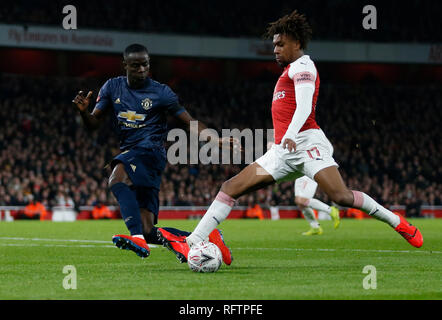 London, UK. 25th Jan, 2019. Manchester United's Eric Bailly (L) vies with Arsenal's Alex Iwobi during the FA Cup fourth round match between Arsenal and Manchester United at the Emirates Stadium in London, Britain on Jan. 25, 2019. Manchester United won 3-1. Credit: Han Yan/Xinhua/Alamy Live News Stock Photo