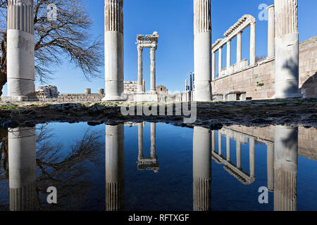 Reflections of the columns of the Temple of Trajan in puddle, in the Roman ruins of Pergamon, known also as Pergamum, in Turkey. Stock Photo