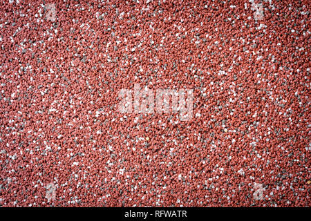 Small red and white stones used for decoration of the facade on the building Stock Photo