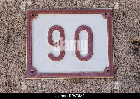 House number plate with number ninety 90 close-up Stock Photo