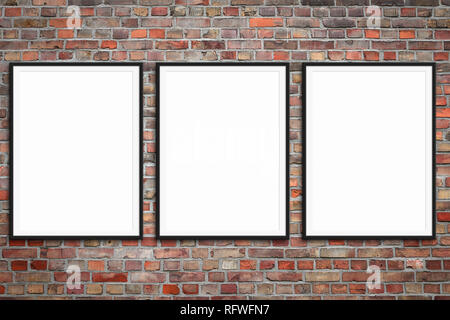three blank picture frames on brick wall -  framed poster mock-up with stone wall background Stock Photo