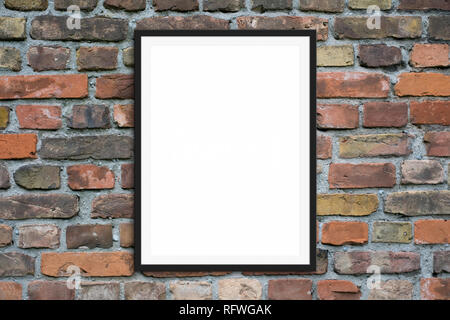 blank picture frame hanging on  brick wall -  framed poster mock-up with stone wall background Stock Photo