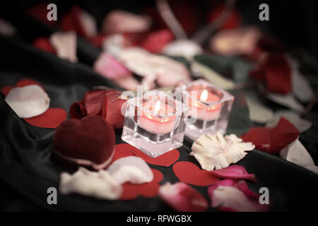 two candles and a ring on a festive background Stock Photo